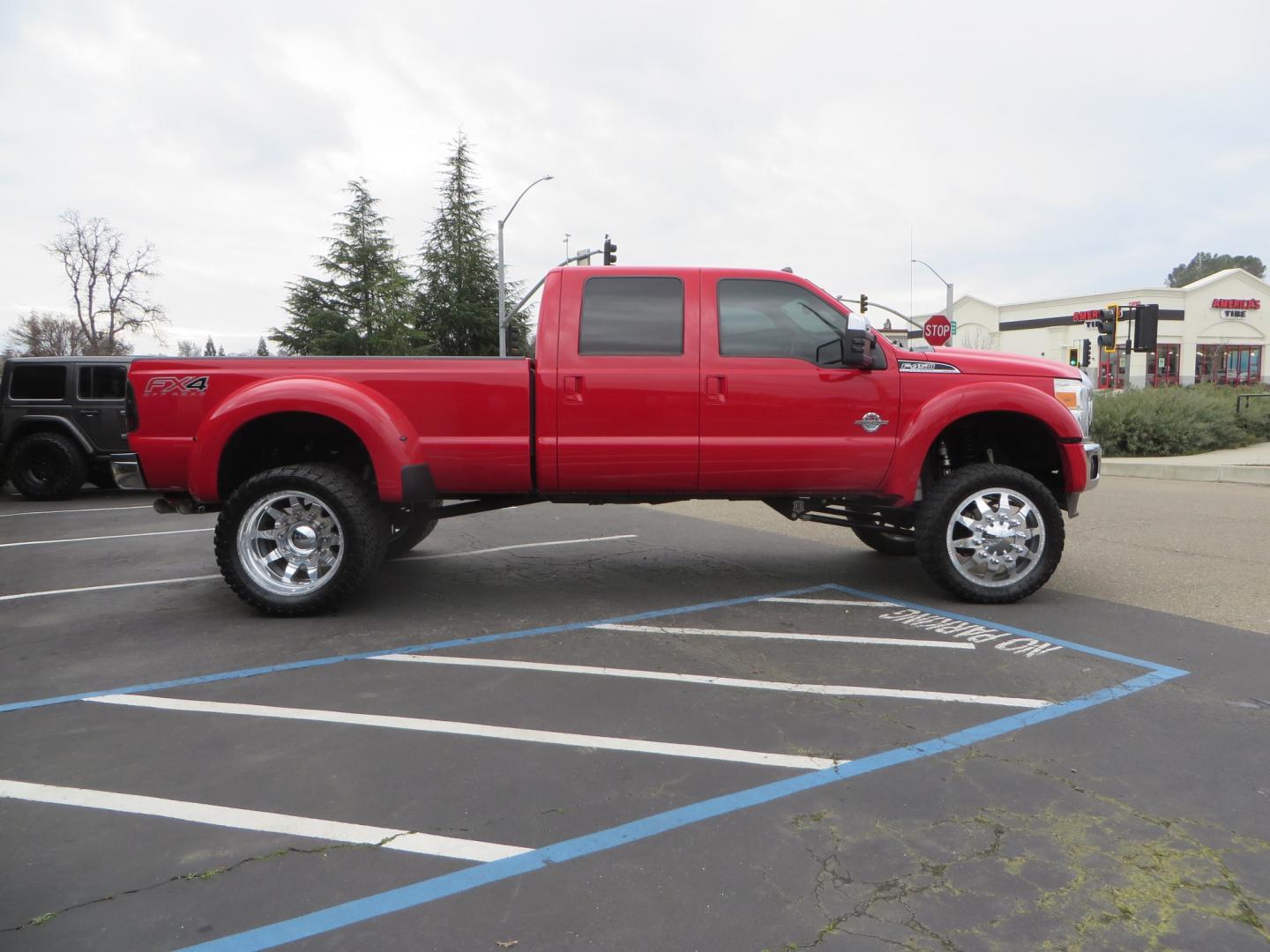 2014 Red /TAN Ford F450 Super Duty Crew Cab Lariat Crew Cab 4WD (1FT8W4DT7EE) with an V8 Turbo Diesel 6.7 Liter engine, Automatic 6-Spd w/SelectShift transmission, located at 2630 Grass Valley Highway, Auburn, CA, 95603, (530) 508-5100, 38.937893, -121.095482 - Wow!! 14 F450 sitting on Icon Vehicle Dynamics suspension, 24" American Force wheels, 37" tires, Rough Country back up leds, Light bar, Window tint, Smoked tail lights 3rd brake light, cab lights, and marker lights, Air bags with compressor, and train horns. Must see this head turner! - Photo#3